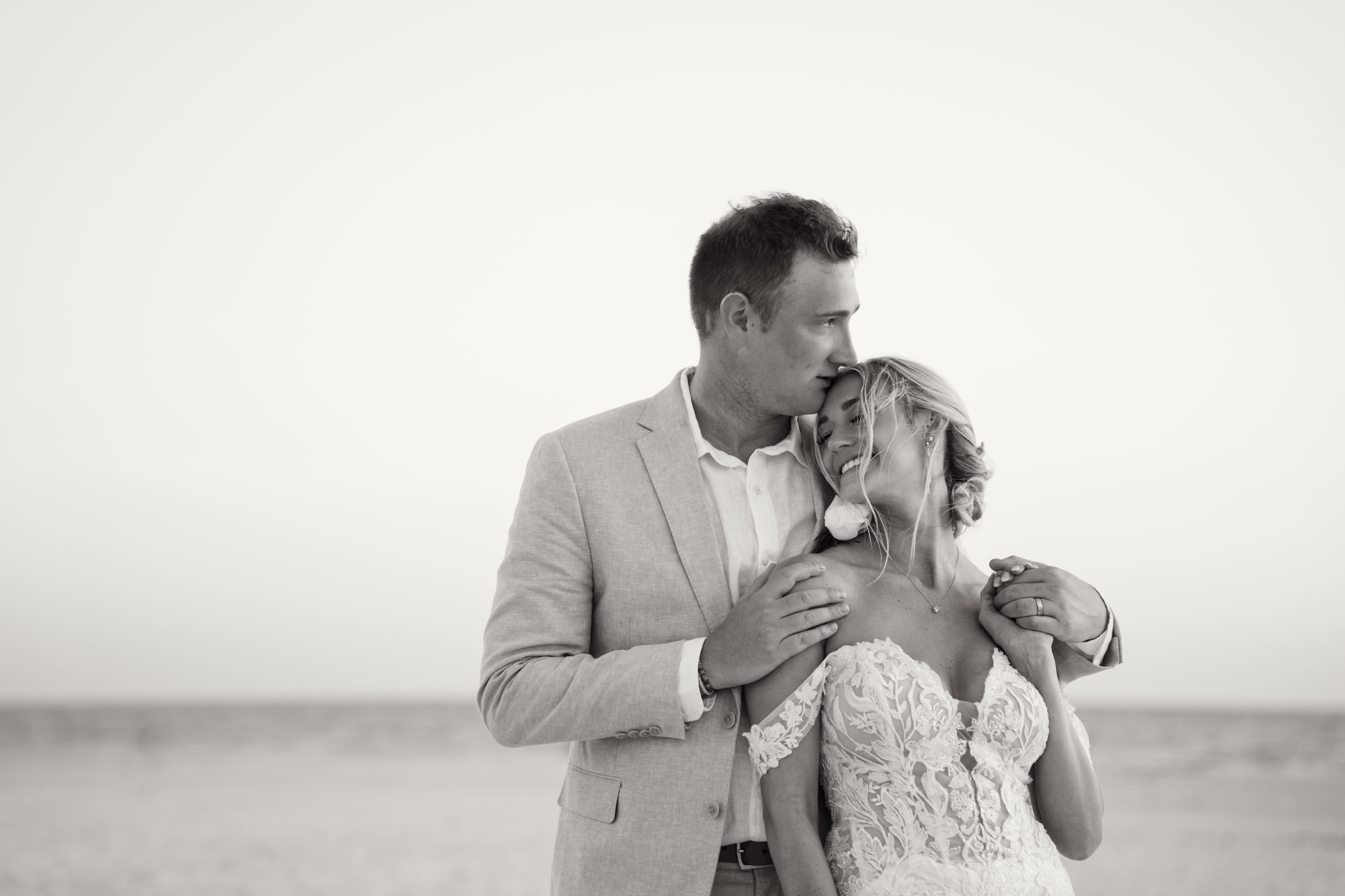 Forehead kiss black and white beach