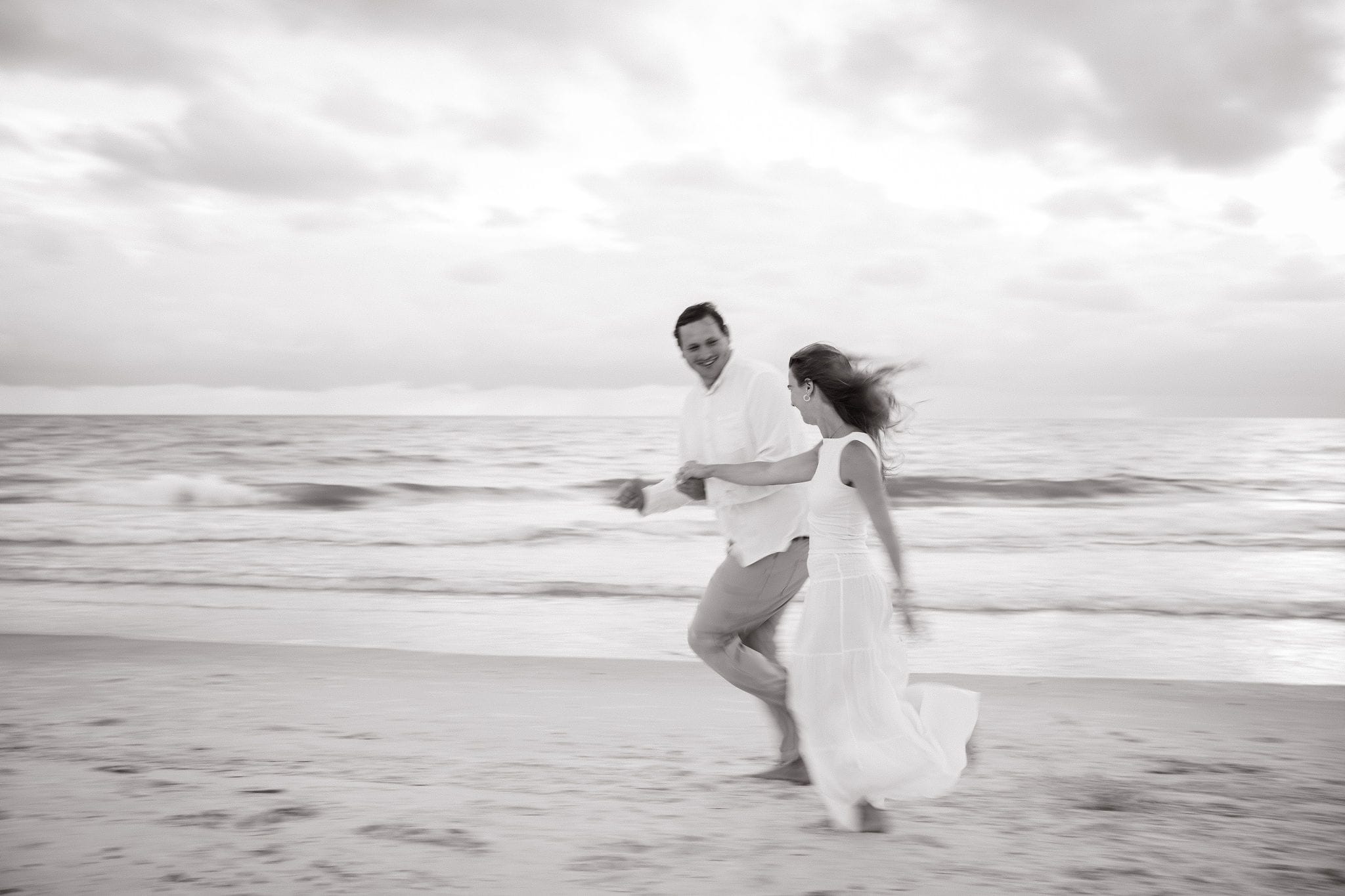 Black and white couple running shoreline
