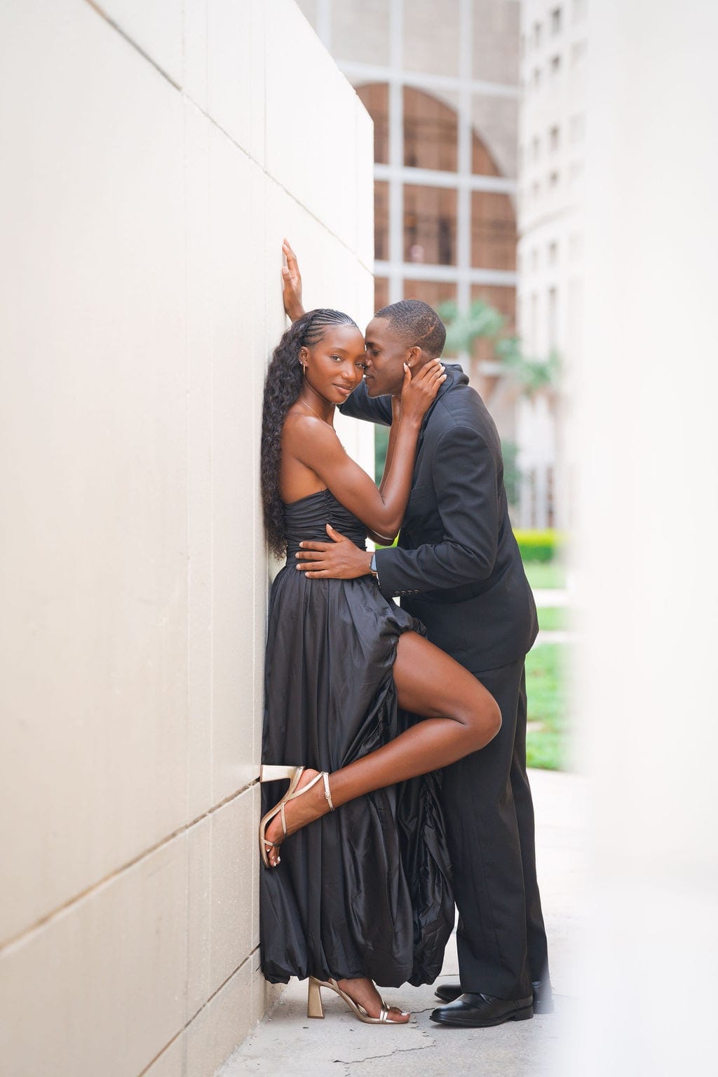 Couple embracing downtown Tampa alley black gown engagement