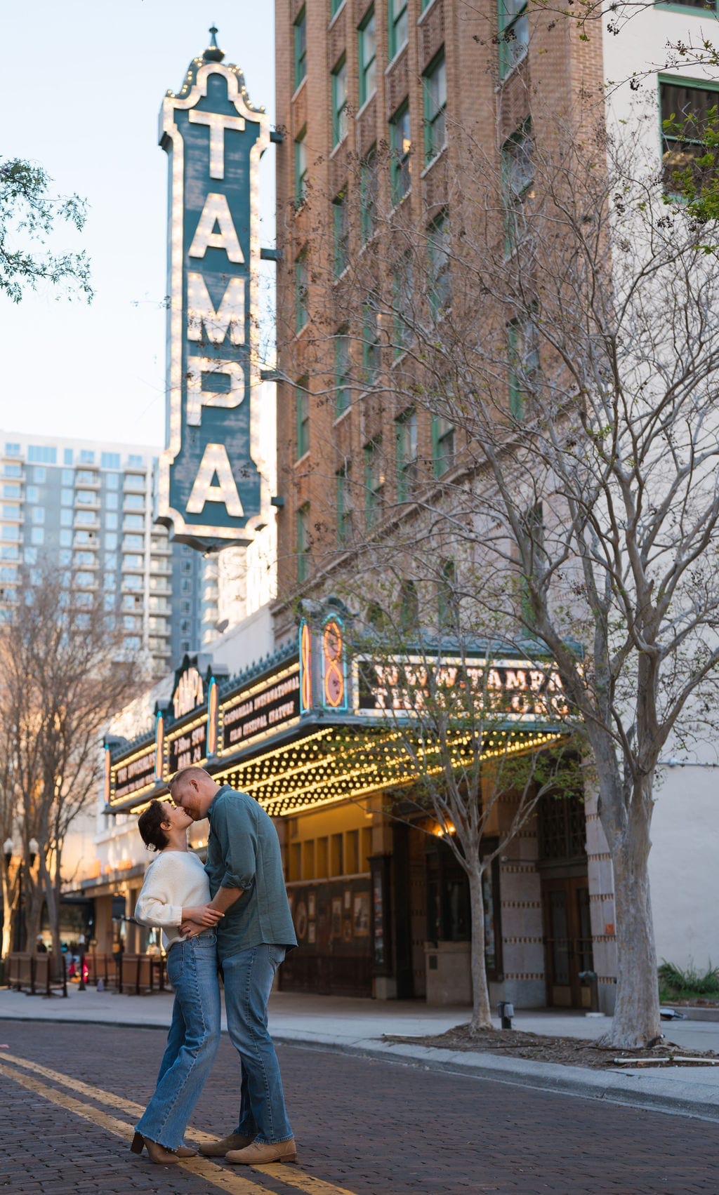 Couple kissing under Tampa theatre marquee downtown Tampa