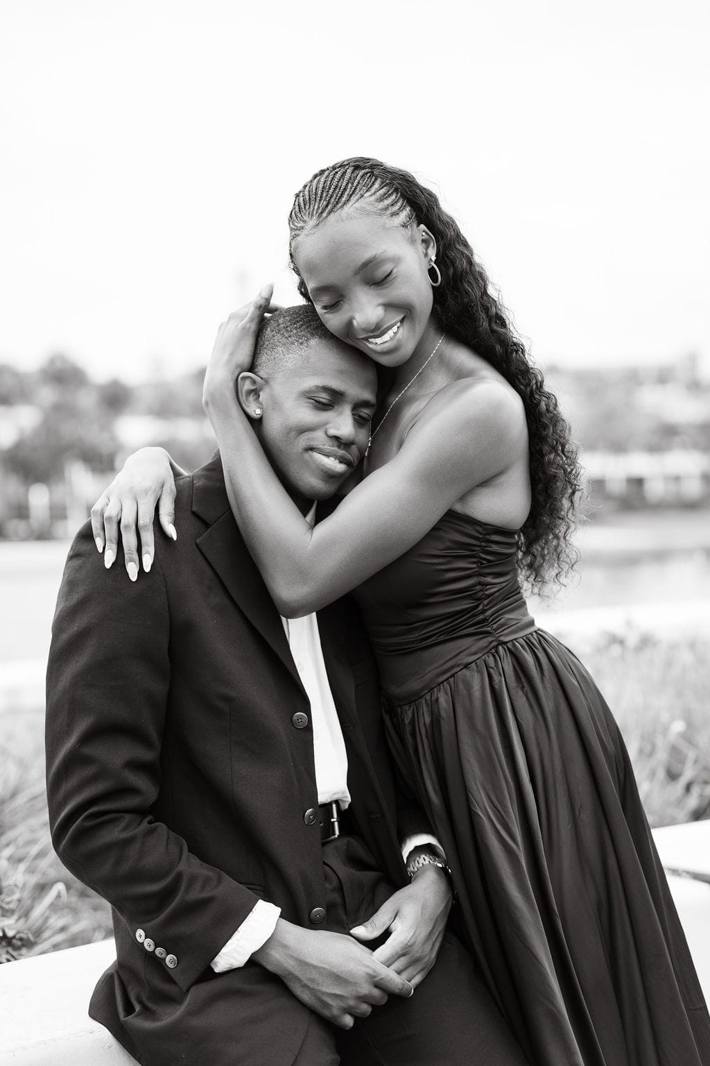 Black and white couple hugging laughing Tampa waterfront
