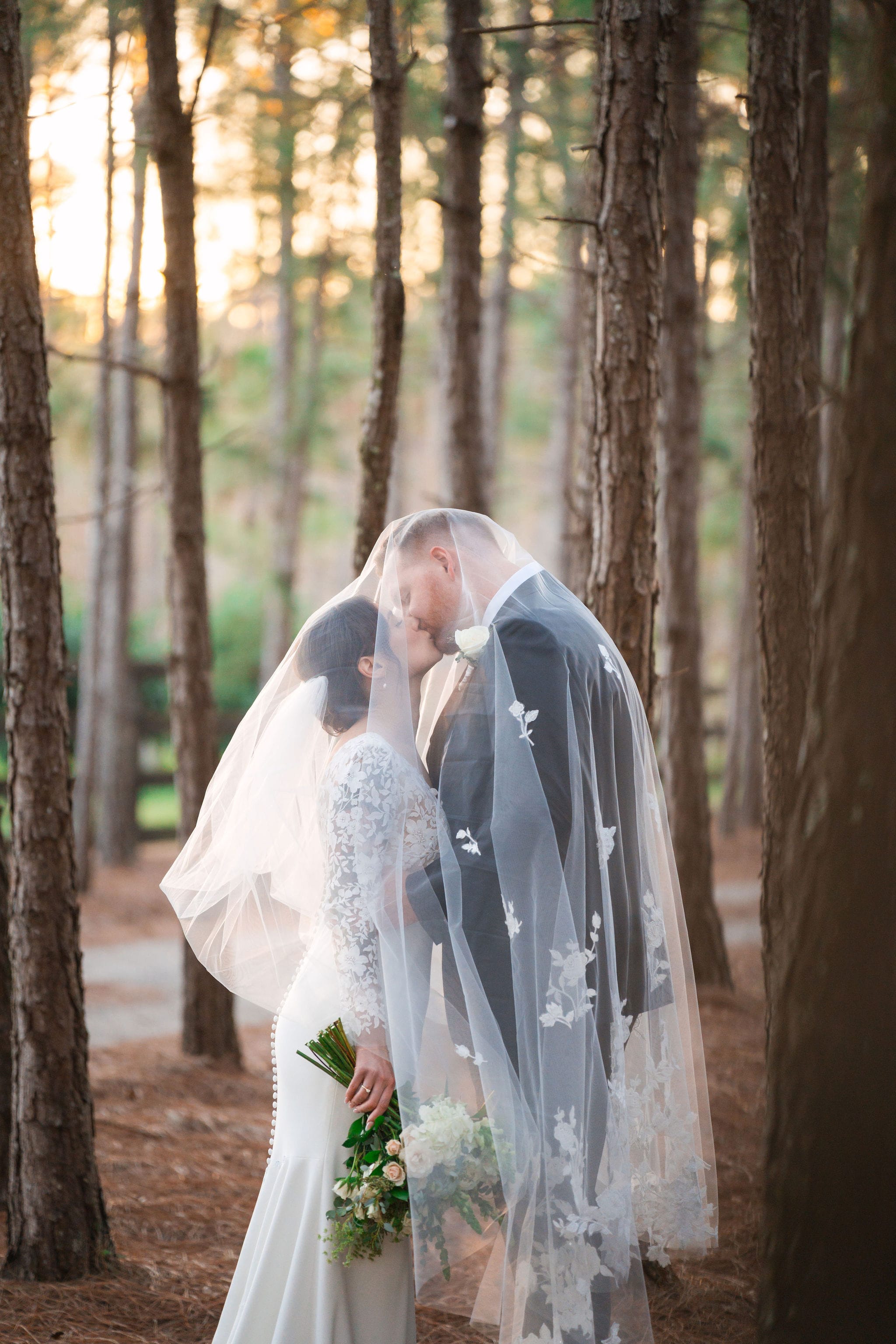 Cascading lace veil kiss pine forest