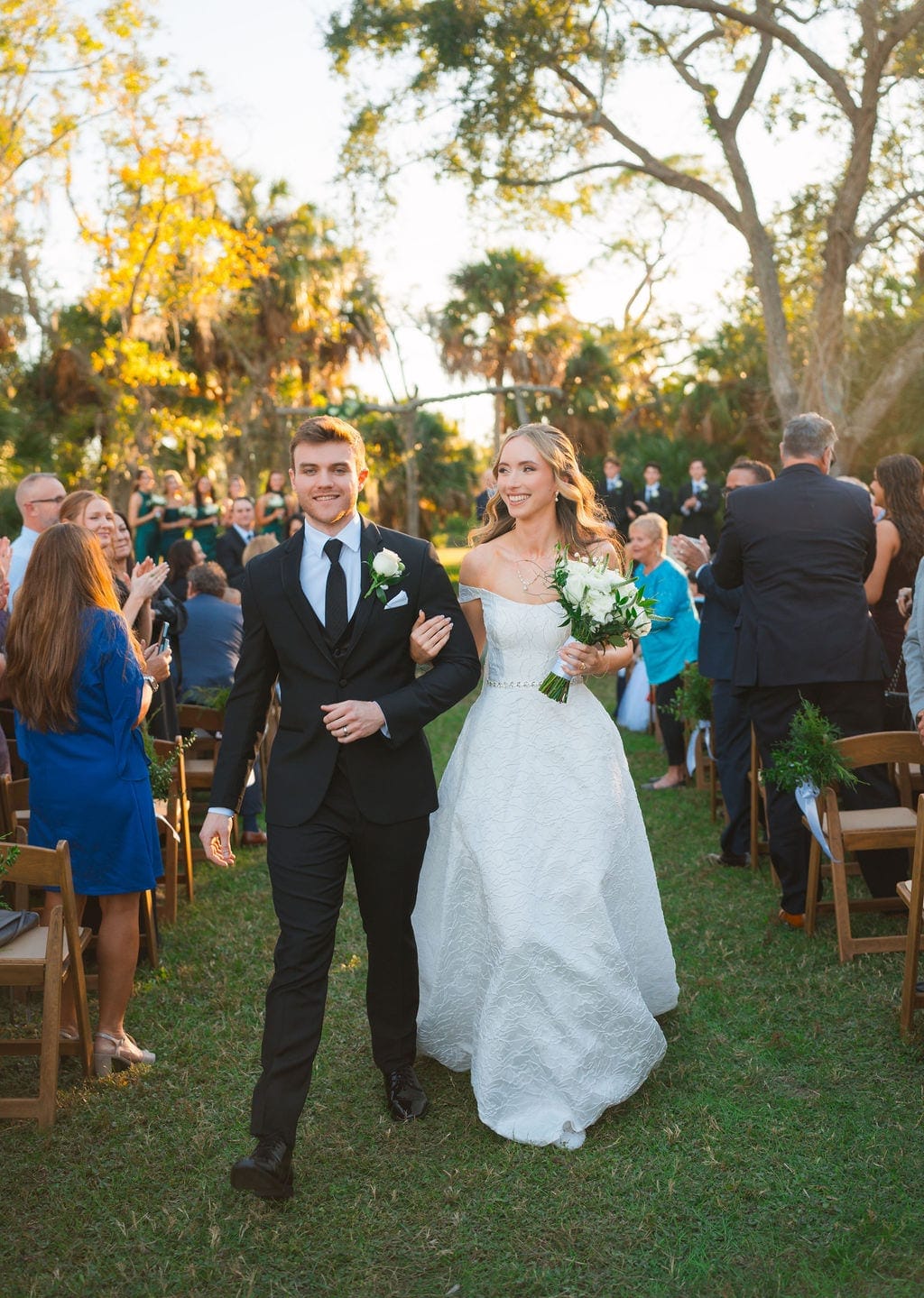 Bride and groom walking down aisle after ceremony oaks