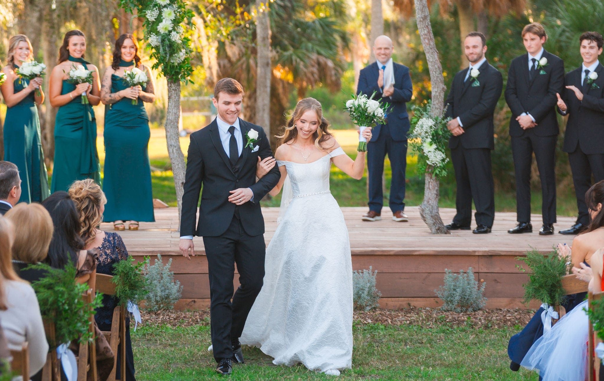 Newlyweds aisle exit golden palms