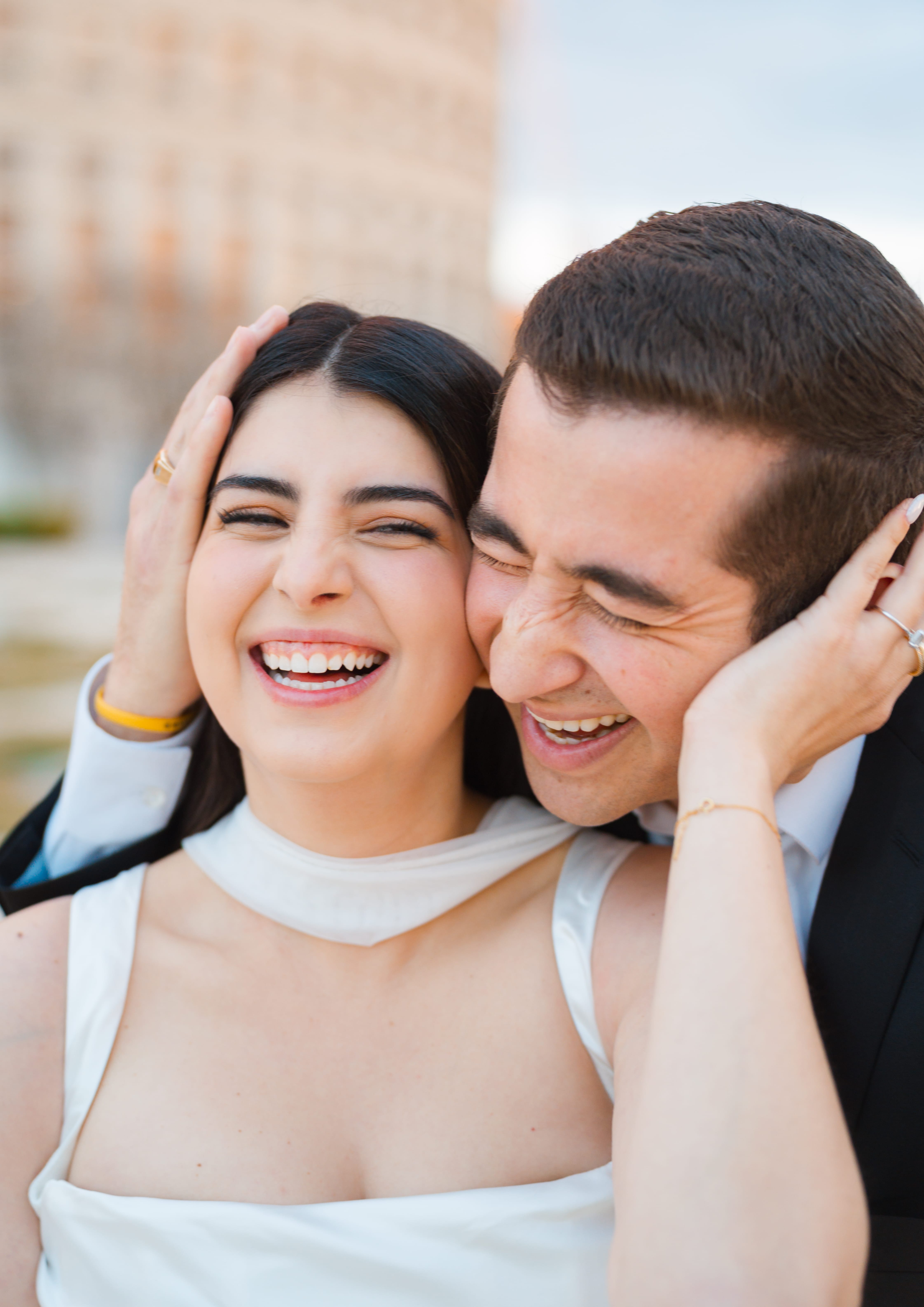 Cheek to cheek laughing couple closeup