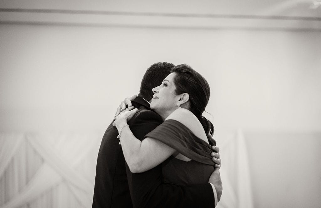 Mother and groom embrace mother son dance black and white