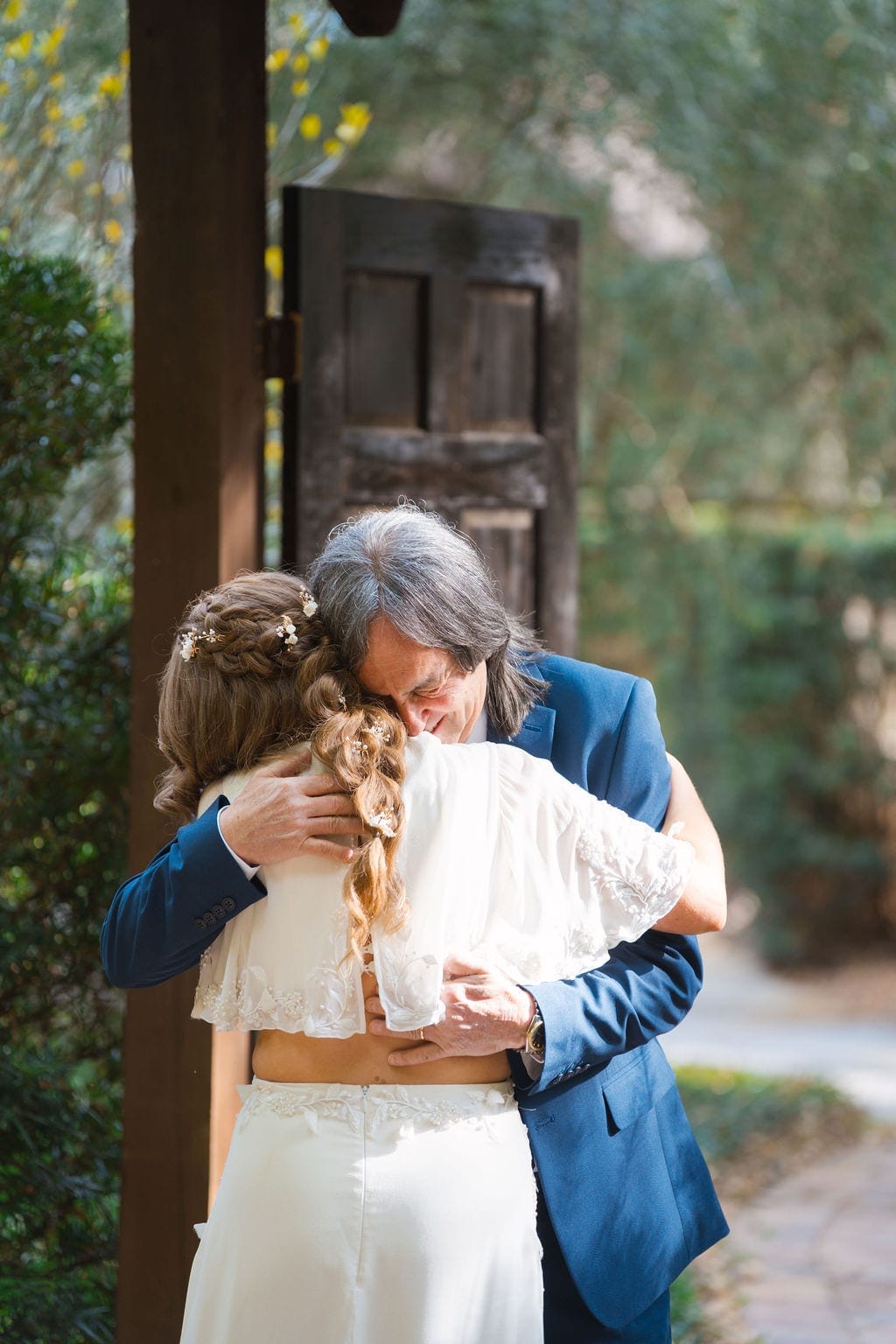 Bride hugging her father before wedding ceremony