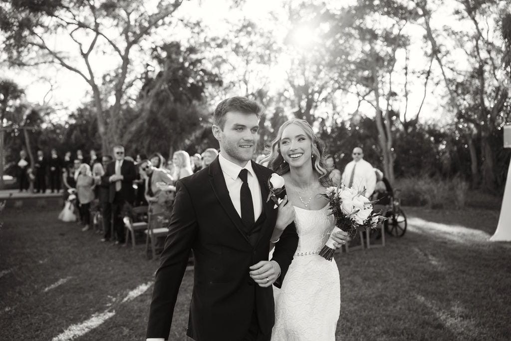 Bride and groom just married black and white backlit oaks