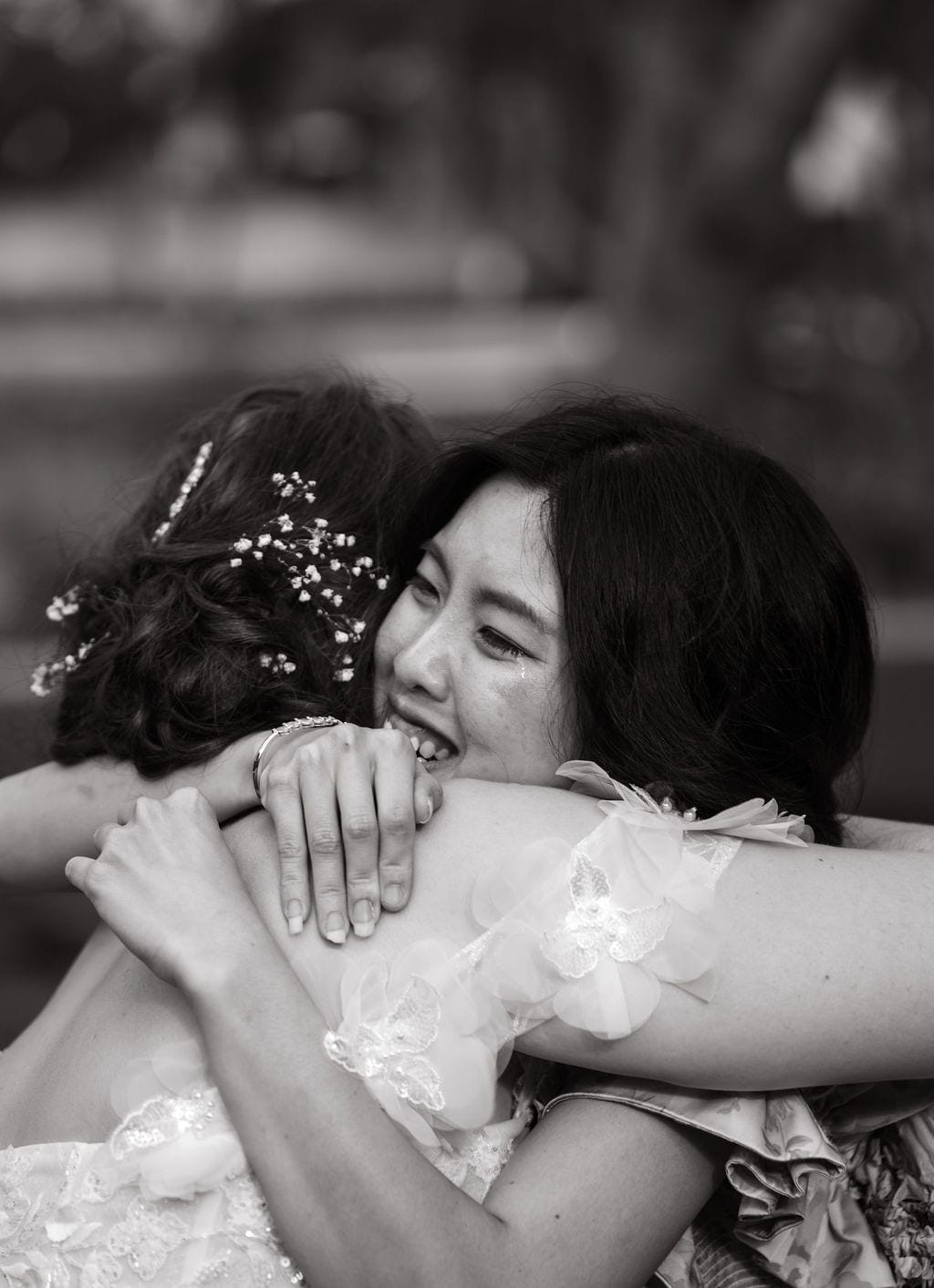 Bride hugging crying loved one black and white wedding