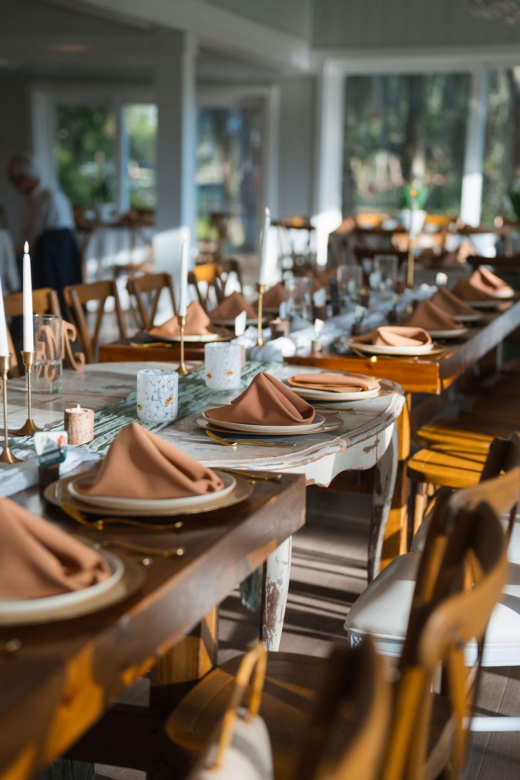Wedding reception farm tables terracotta napkins taper candles