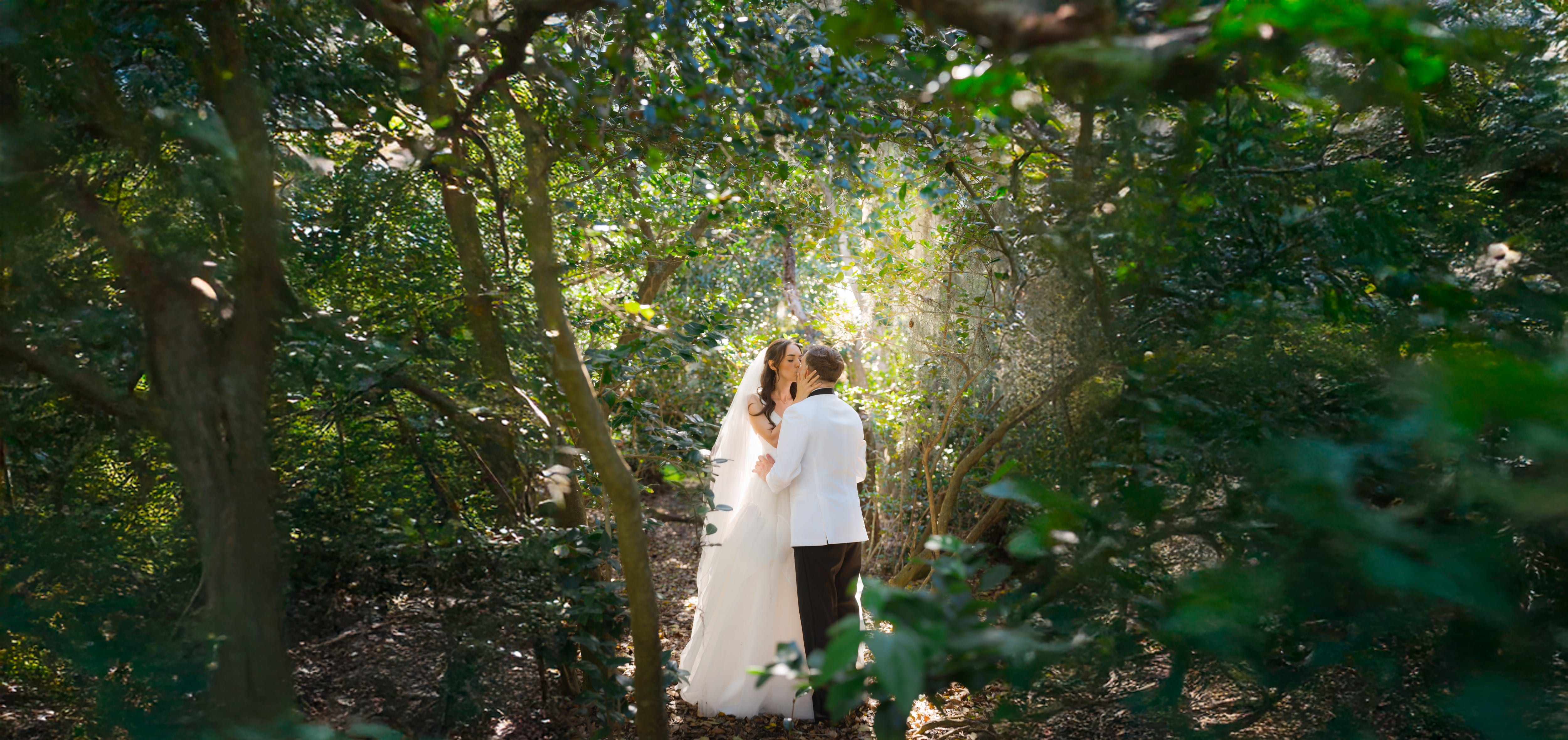 Couple kiss forest tunnel sunbeam tampa wedding