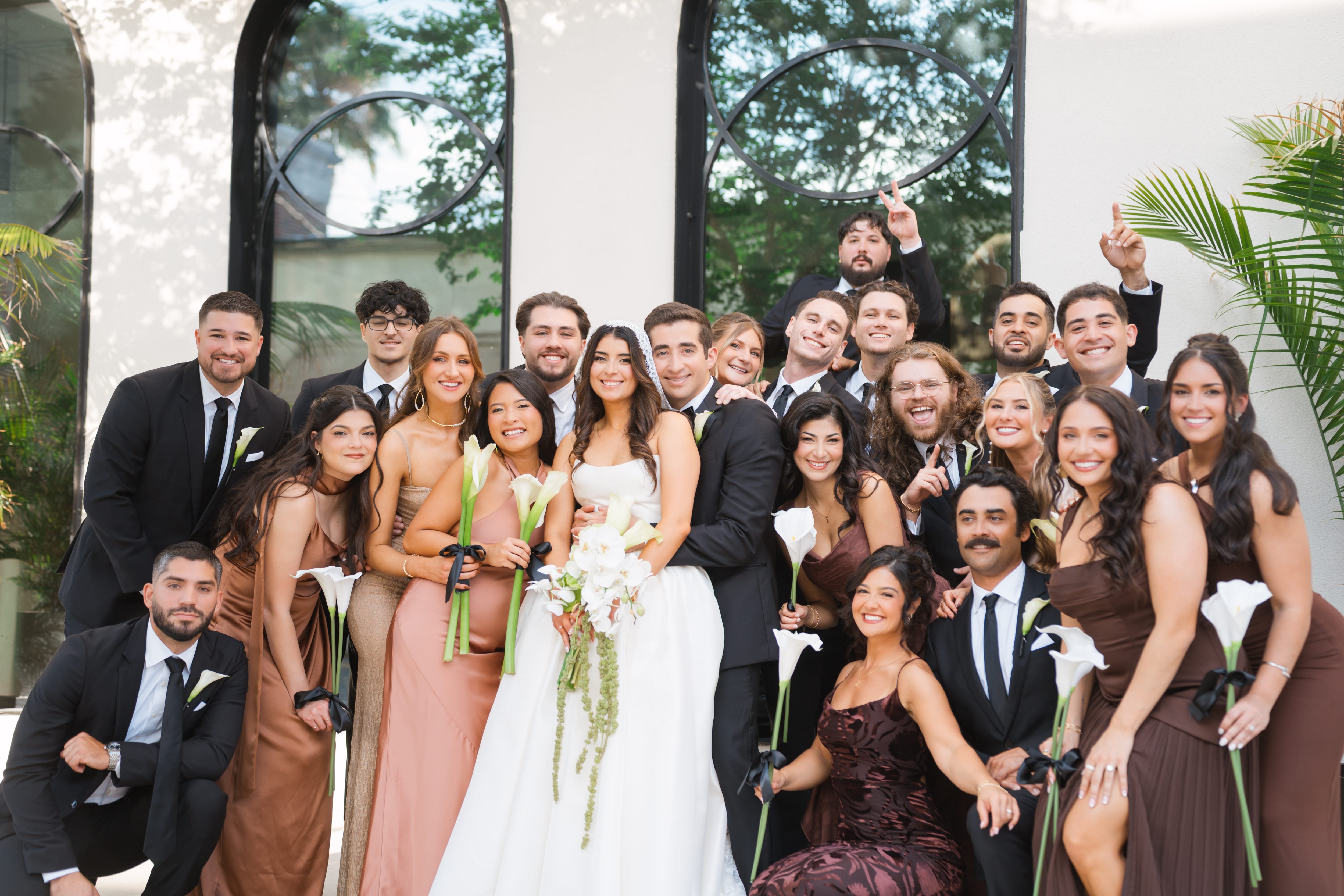 Full wedding party black arched windows