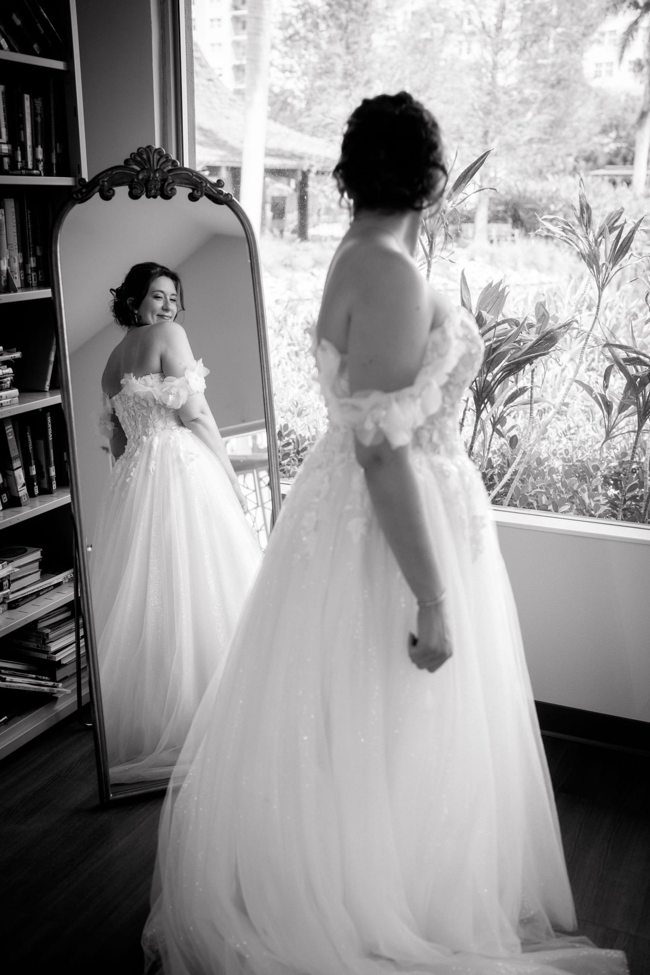 Bride reflected in a mirror while getting ready, black and white