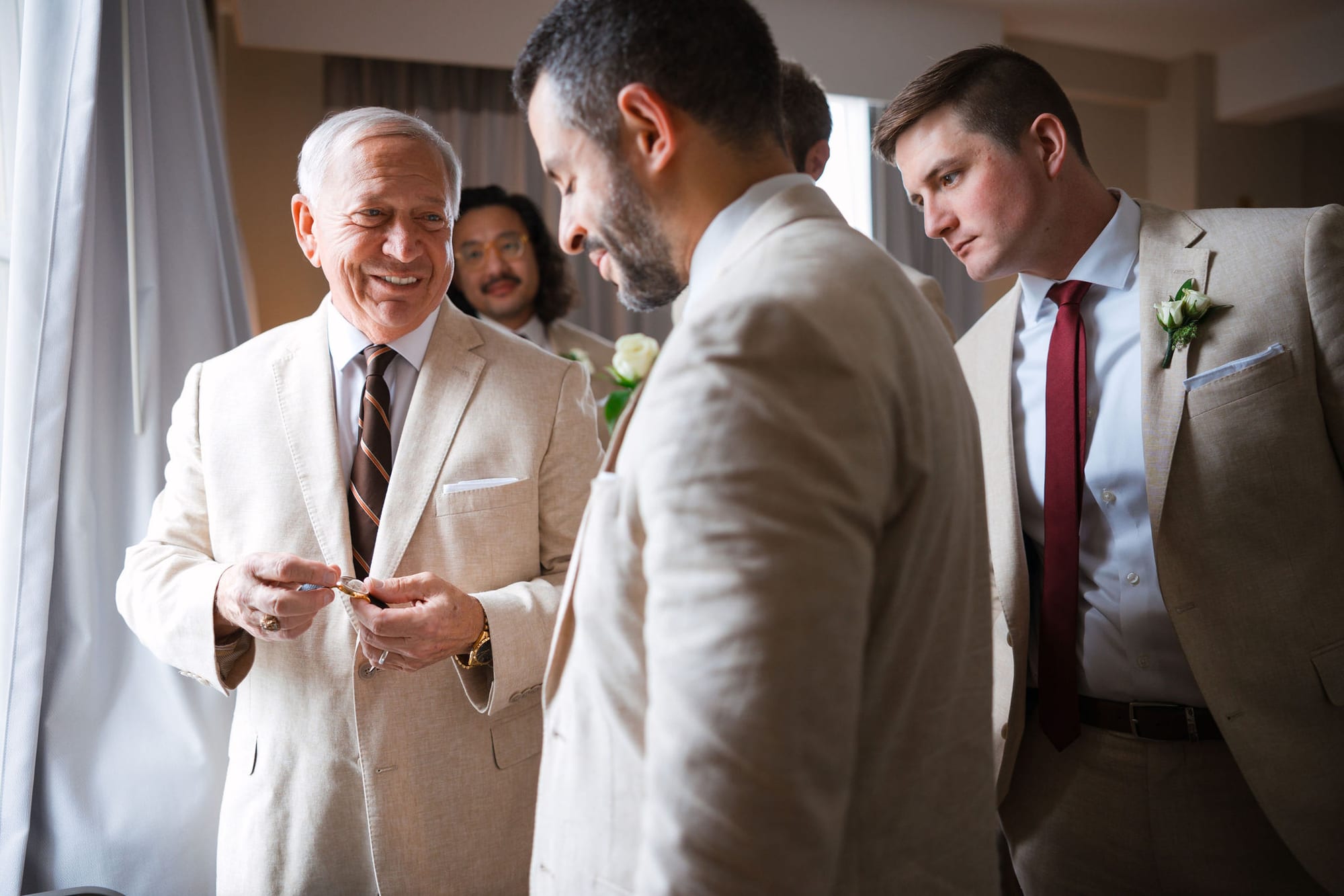 Groom getting ready with his father and groomsmen before a Tampa wedding