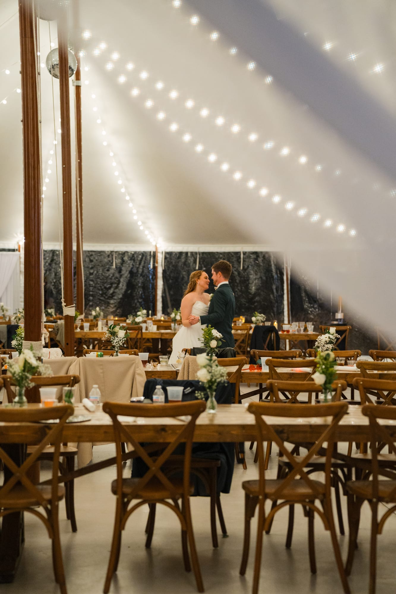 Bride standing alone in the reception tent before guests arrive