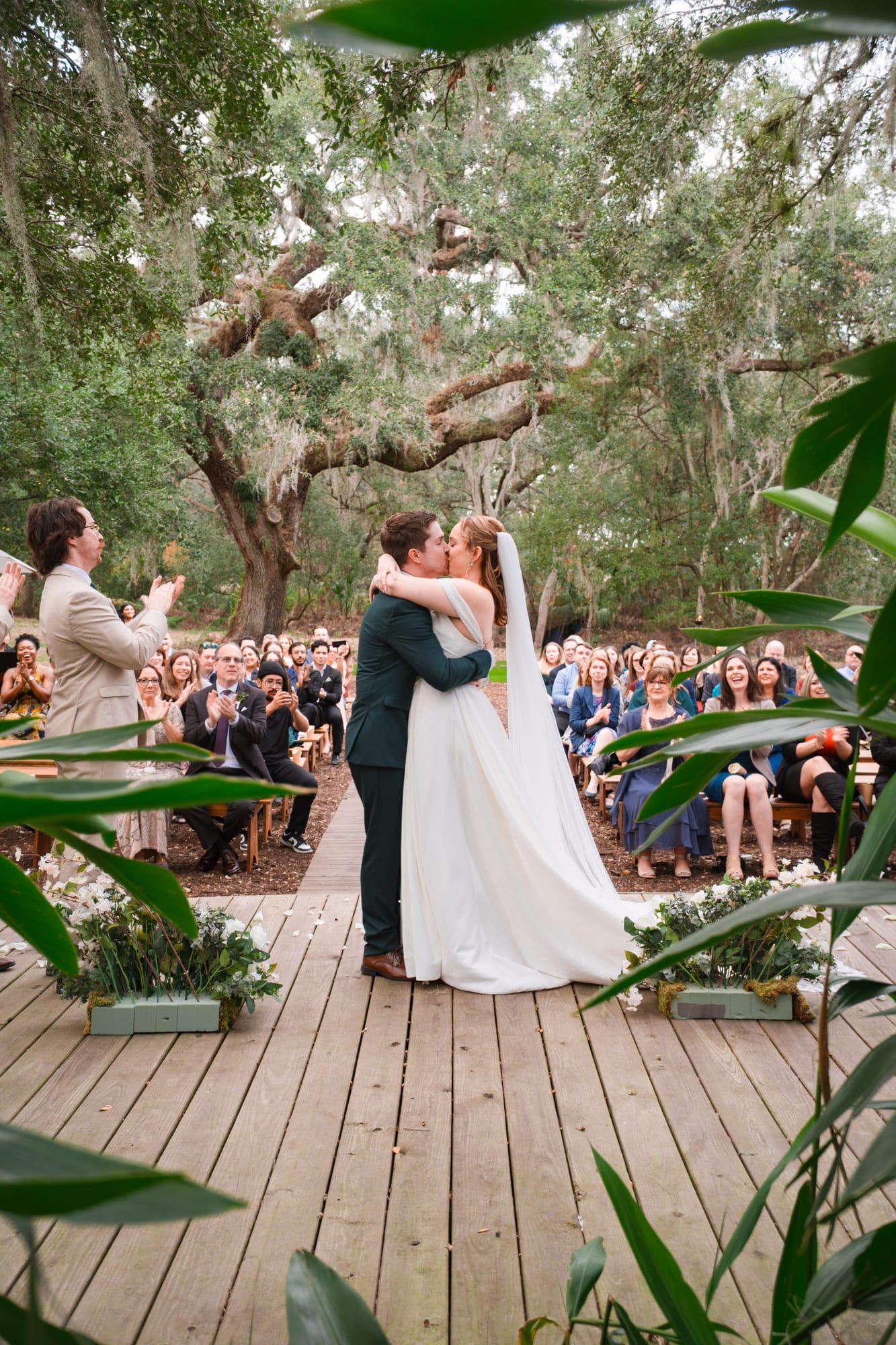 Wedding ceremony under The Broken Oak at Mill Pond Estate in Seffner Florida with guests seated on both sides