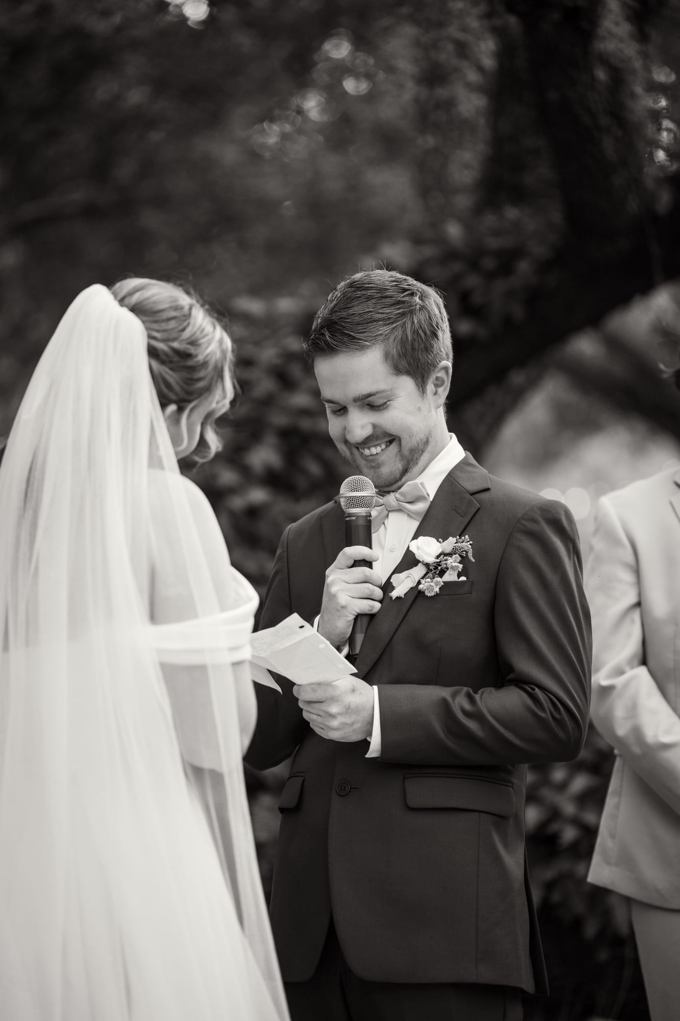 Bride and groom exchanging vows in black and white