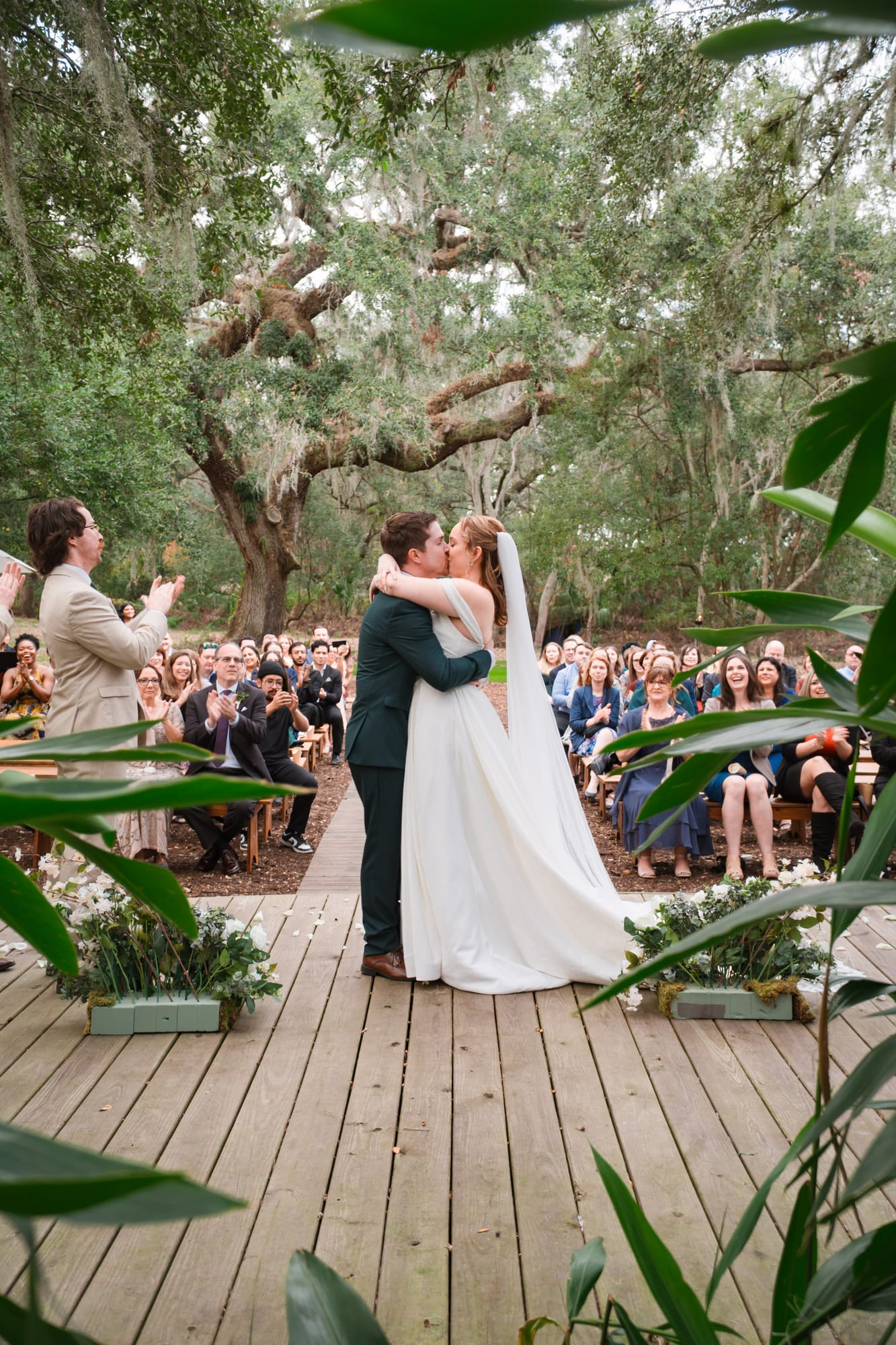 Bride and groom share their first kiss under The Broken Oak