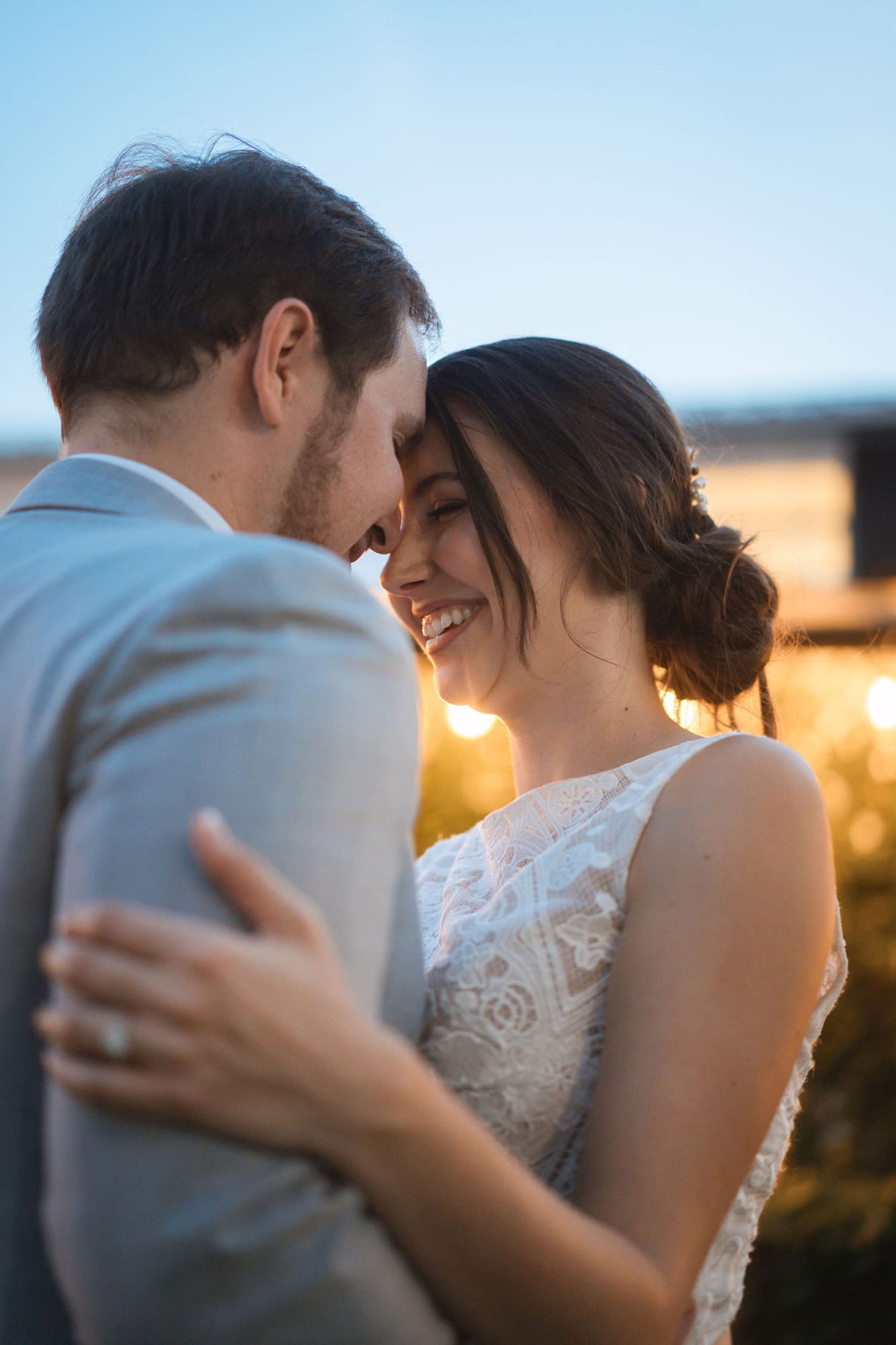 Bride and groom backlit by warm sunset light at SoireEstate