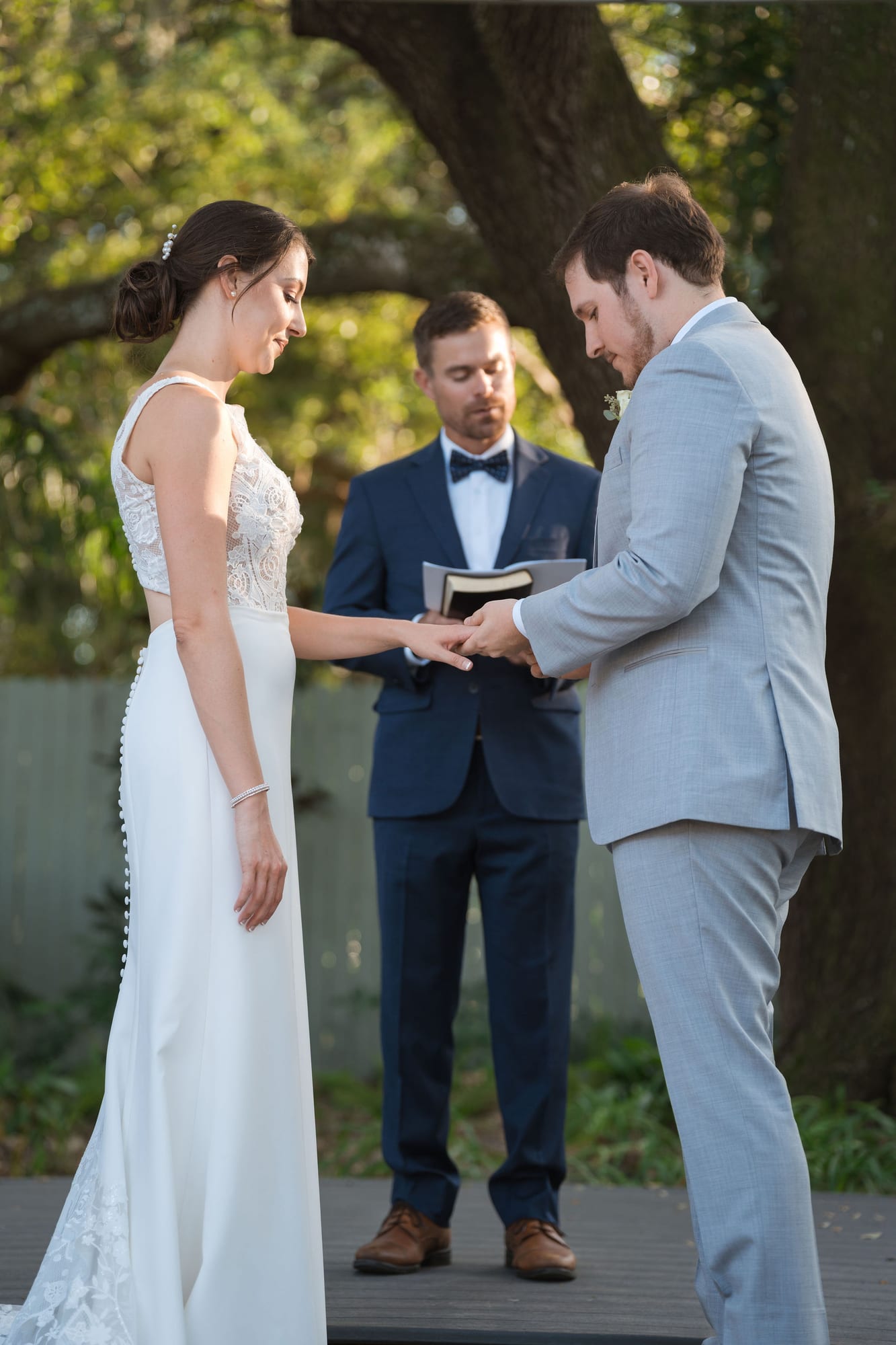 Bride and groom exchanging rings during their garden ceremony