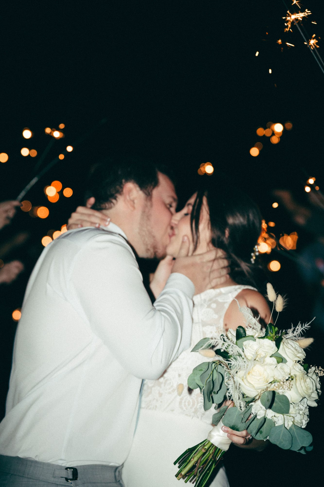 Bride and groom kissing during their sparkler send off at SoireEstate in Lutz Florida
