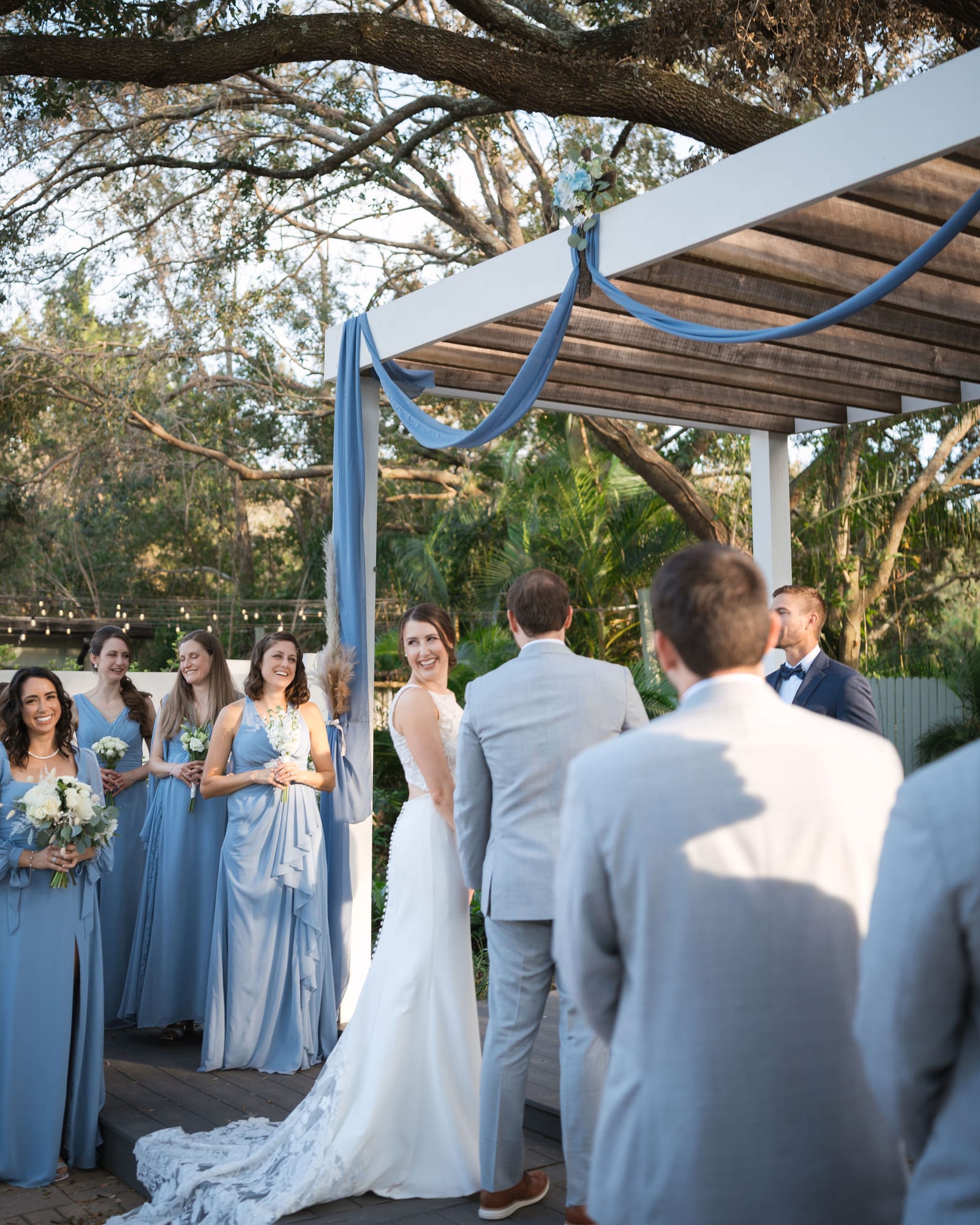 Wedding ceremony under the draped pergola and live oaks at SoireEstate in Lutz Florida