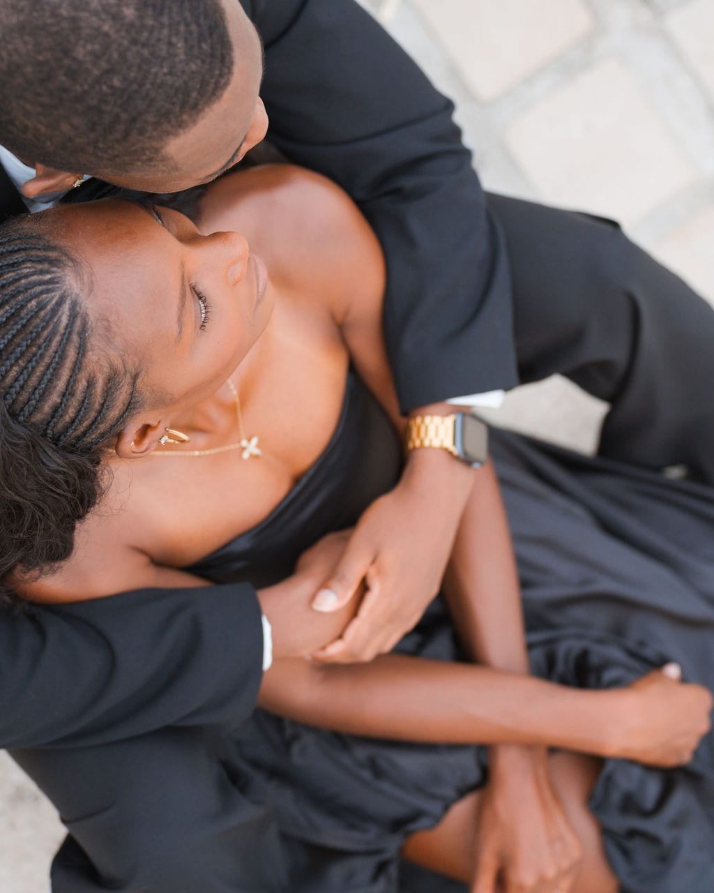Overhead portrait of a couple embracing in black formal attire