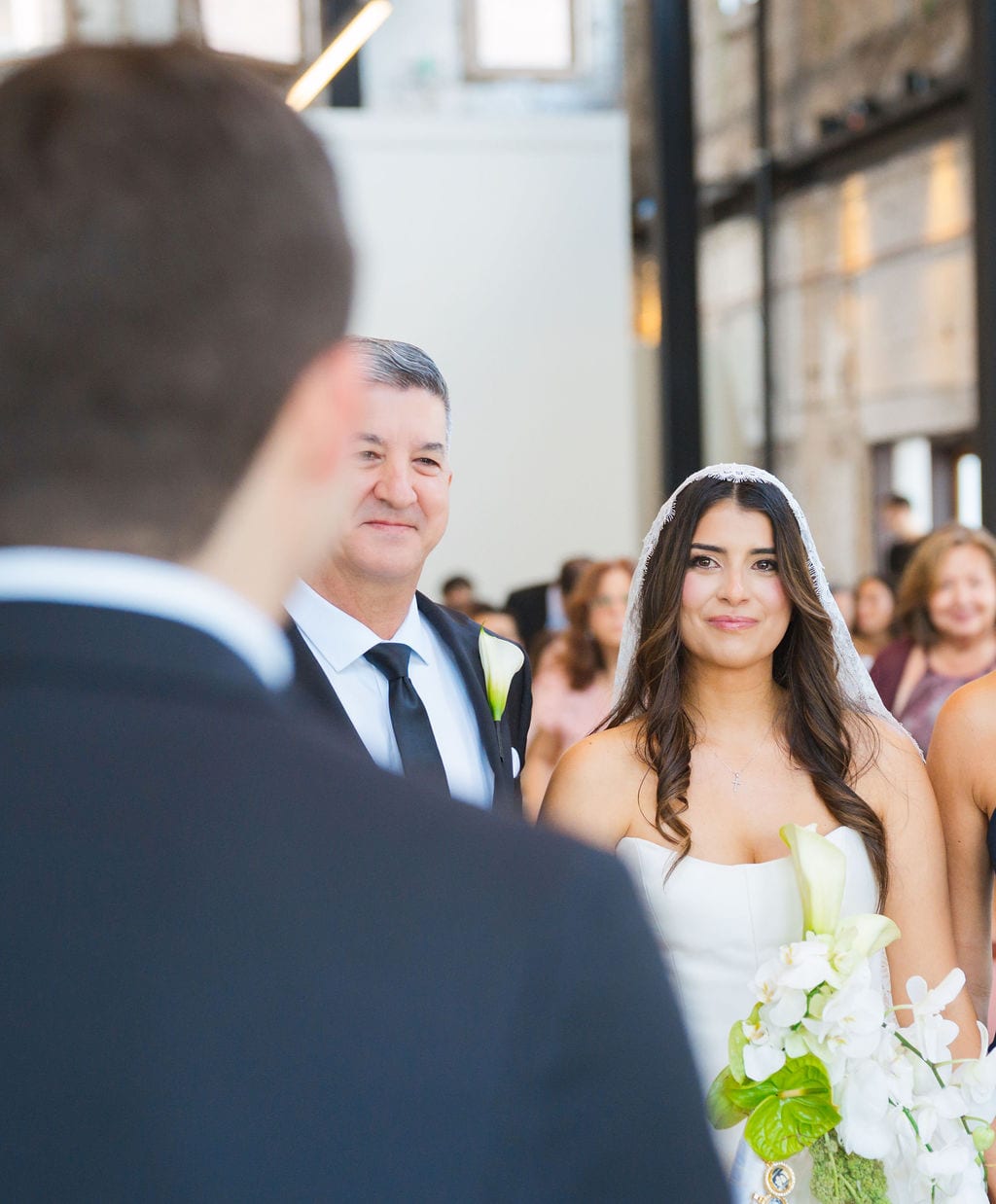 Bride walking down the aisle with her father toward the groom